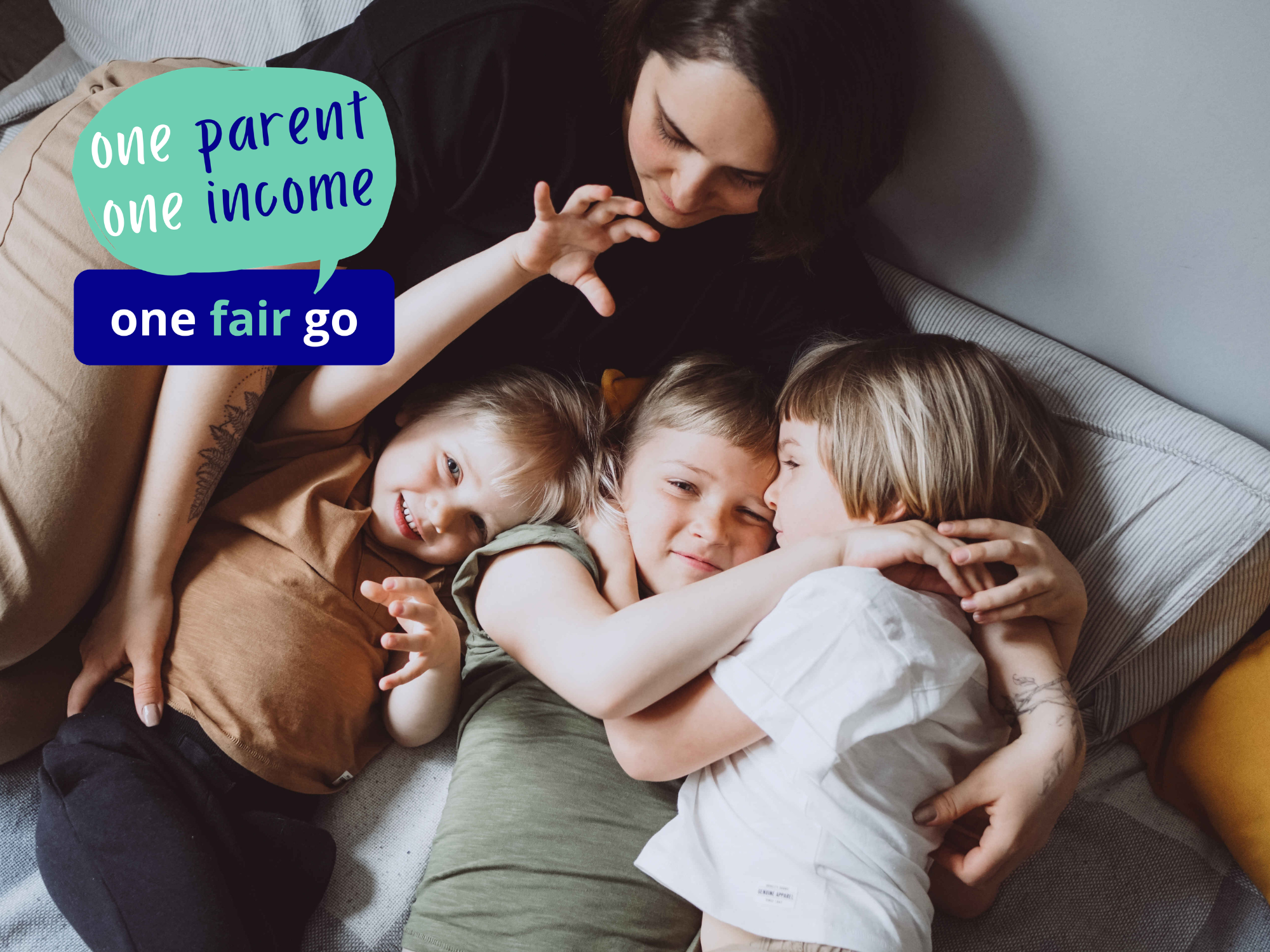 Newsletter3cropped Woman lying on bed cuddling her three young children.